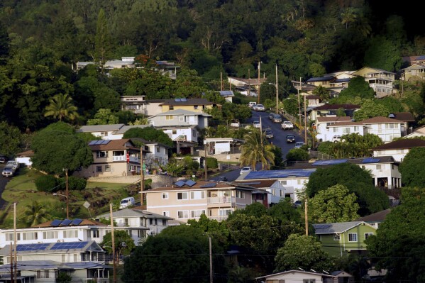 FILE - A neighborhood of single-family homes is shown Thursday, Dec. 24, 2015, in Honolulu. Forecasters say this year's hurricane season for waters around Hawaii will likely be “below-normal” with one to four tropical cyclones across the central Pacific region. (AP Photo/Audrey McAvoy, File)