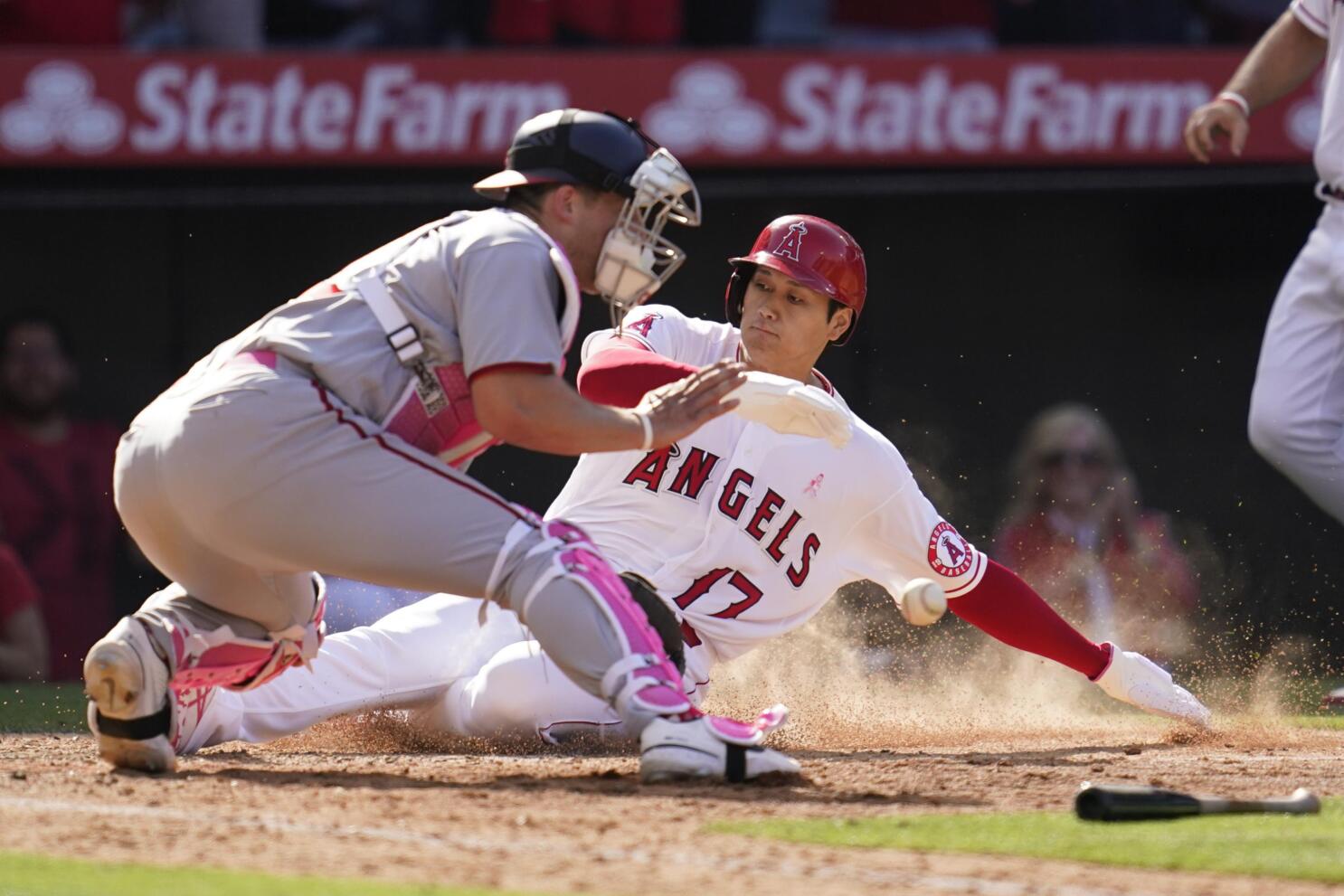 Trout homers, Angels rally in 8th to hand Astros 1st loss