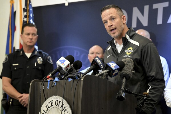Ontario Christian High School Principal Benjamin Dykhouse addresses the media during a press conference as Ontario Police Chief Michael Lorenz, left, looks on, following the arrest of Ontario Christian High School senior Sebastian Villasenor in Ontario, Calif., Wednesday, Feb. 14, 2024. The 18-year-old student who had researched school shootings and had an arsenal of guns at his home was charged Wednesday with planning to attack a Southern California campus. (Will Lester/The Orange County Register via AP)