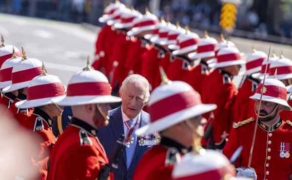 King Charles inspects an honorary guard when he arrives on Tuesday, May 27, 2025, in front of the Senate building in Ottawa, Canada (Christinne Muschi/The Canadian Press via AP)