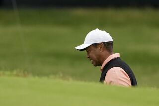 Tiger Woods grimaces on the 18th hole during the third round of the PGA Championship golf tournament at Southern Hills Country Club, Saturday, May 21, 2022, in Tulsa, Okla. (AP Photo/Matt York)