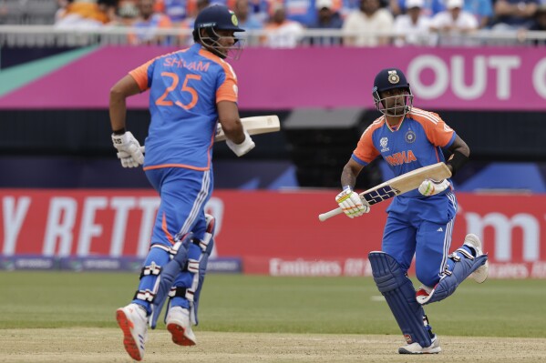 India's Suryakumar Yadav, right, and Shivam Dube run between the wickets to score during the ICC Men's T20 World Cup cricket match between United States and India at the Nassau County International Cricket Stadium in Westbury, New York, Wednesday, June 12, 2024. (AP Photo/Adam Hunger)