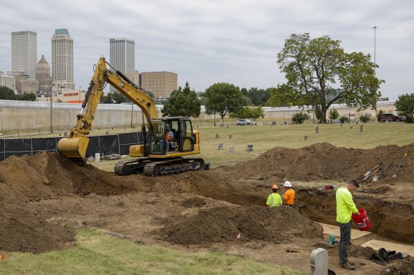 FILE - Researchers work in Oaklawn Cemetery as they search for victims of the 1921 Tulsa Race Massacre Monday, Sept. 11, 2023 in Tulsa, Okla. The latest search for remains of victims of the 1921 Tulsa Race Massacre has ended with 59 graves found and seven sets of remains exhumed. Oklahoma state archaeologist Kary Stackelbeck said excavation ended Friday, Sept. 29 with the exhumed remains taken to an onsite forensic laboratory to begin efforts to identify them and determine the causes of their deaths. (Mike Simons /Tulsa World via AP)