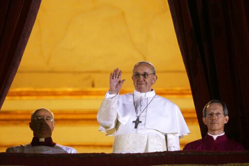 Argentine Cardinal Jorge Bergoglio, who chose the name of Pope Francis, waves to the crowd from the central balcony of St. Peter's Basilica after being elected 266th pontiff of the Roman Catholic Church, at the Vatican, Wednesday, March 13, 2013. (AP Photo/Gregorio Borgia, file)