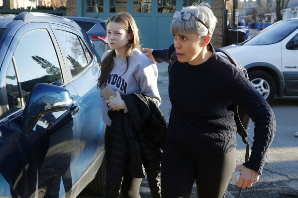 Deb Mell, right, escorts her niece Anne Blagojevich, former Illinois Gov. Rod Blagojevich's daughter, into Blagojevich's home after her day on school Tuesday, Feb. 18, 2020, in Chicago. President Donald Trump on Tuesday commuted what he called the "ridiculous" 14-year prison sentence handed out to former Illinois Gov. Rod Blagojevich for political corruption, clearing the way for his release after more than eight years behind bars.(AP Photo/Charles Rex Arbogast)