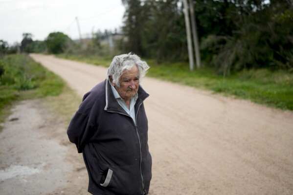 Former Uruguayan President Jose “Pepe” Mujica stands outside his home in Montevideo, Uruguay, Saturday, July 22, 2023. Mujica is Uruguay’s best-known atheist and “none.” He gained respect globally for his simple ways. He donated most of his salary to charity and declined to live in the presidential mansion. His social agenda included laws approving same-sex marriage and creating the world’s first national marketplace for legal marijuana. (AP Photo/Natacha Pisarenko)