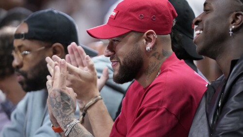 Brazilian soccer player Neymar watches during the first half of Game 4 of the basketball NBA Finals between the Miami Heat and the Denver Nuggets, Friday, June 9, 2023, in Miami. (AP Photo/Wilfredo Lee)