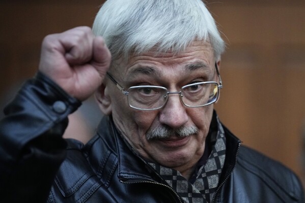 Oleg Orlov, a member of the Board of the International Historical Educational Charitable and Human Rights Society 'Memorial' (International Memorial) gestures after a court session in Moscow, Russia, Wednesday, Oct. 11, 2023. The court ordered Orlov, co-chair of the Nobel Peace Prize-winning human rights group Memorial, to pay a fine of nearly $1,500 on the charges of 