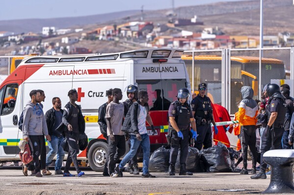 Migrants arrive at Puerto del Rosario on the Canary island of Fuerteventura, Spain, Tuesday Oct. 3, 2023. Emergency services on the Spanish Canary Islands say more than 500 migrants have reached the nearby island of Hierro in four large wooden boats since Monday. One of the boats was carrying 280 migrants. (Europa Press via AP)