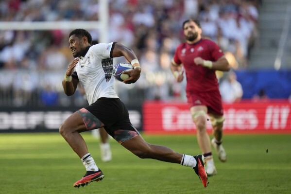 Fiji's Ilaisa Droasese runs with the ball during the Rugby World Cup Pool C match between Fiji and Georgia at the Stade de Bordeaux in Bordeaux, France, Saturday, Sept. 30, 2023. (AP Photo/Thibault Camus)
