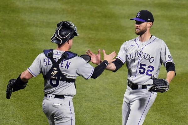 Colorado Rockies relief pitcher Daniel Bard left fielder Connor Joe (9) and  catcher Elias Diaz at the end of a baseball game against the Chicago Cubs  in Chicago, Sunday, Sept. 18, 2022. (