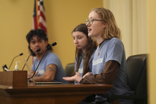 Libby Kramer, of Climate Generation, right, speaks to the Minnesota Youth Council, Tuesday, Feb. 27, 2024, in St. Paul, Minn. The advocates called on the council, a liaison between young people and state lawmakers, to support a bill requiring schools to teach more about climate change. (AP Photo/Abbie Parr)
