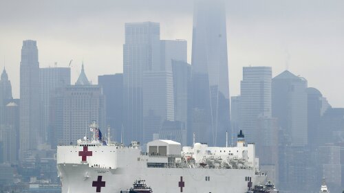 The Navy hospital ship USNS Comfort passes lower Manhattan on its way to docking in New York, Monday, March 30, 2020. The ship has 1,000 beds and 12 operating rooms that could be up and running within 24 hours of its arrival on Monday morning. It's expected to bolster a besieged health care system by treating non-coronavirus patients while hospitals treat people with COVID-19. AP Photo/Seth Wenig)