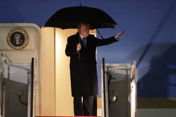 President Donald Trump waves from the stairs of Air Force One upon his arrival at Joint Base Andrews, Md., Monday, March 17, 2025. (AP Photo/Luis M. Alvarez)