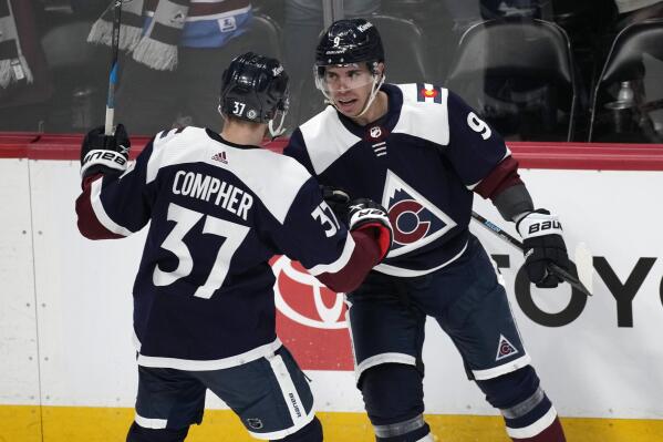Colorado Avalanche left wing J.T. Compher, left, congratulates center Evan Rodrigues after Rodrigues scored the go-ahead goal in the third period of an NHL hockey game against the Winnipeg Jets, Thursday, April 13, 2023, in Denver. (AP Photo/David Zalubowski)