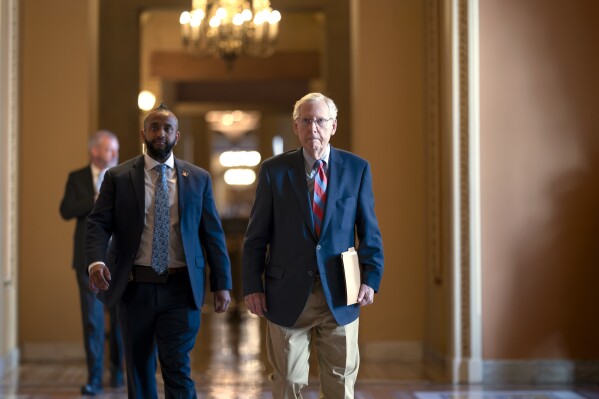 Senate Minority Leader Mitch McConnell, R-Ky., walks to the chamber to work on a package of wartime funding for Ukraine, Israel and other U.S. allies, at the Capitol in Washington, Friday, Feb. 9, 2024. (AP Photo/J. Scott Applewhite)