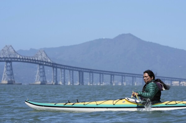Juan Bay, president of the Waorani people of Ecuador, kayaks in the San Francisco Bay toward the Chevron Long Wharf, Thursday, June 19, 2025, in Richmond, Calif. (AP Photo/Godofredo A. Vásquez)