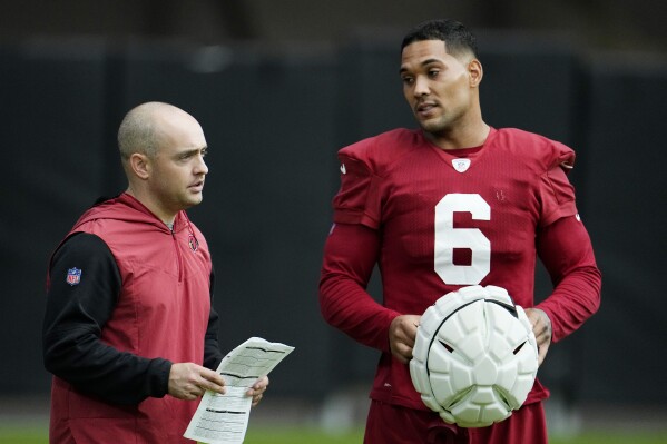 Arizona Cardinals offensive coordinator Drew Petzing, left, talks with running back James Conner (6) during NFL football training camp practice at State Farm Stadium, Monday, Aug. 7, 2023, in Glendale, Ariz. (AP Photo/Ross D. Franklin)