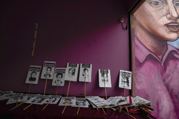 Protest posters showing images of those disappeared during the Augusto Pinochet military dictatorship are stored in a room of the human rights group, Association of Families of the Detained-Disappeared, in Santiago, Chile, Friday, Aug. 18, 2023. Pinochet died in 2006 without being convicted of any crimes. The Documentation and Archive Foundation of the Vicariate of Solidarity continues to seek justice through the use of their archive that preserves 47,000 instances of human rights violations during the Pinochet regime. (AP Photo/Esteban Felix)