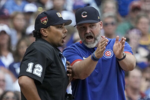 CORRECTS UMPIRE TO ERICH BACCHUS, INSTEAD OF GERRY DAVIS - Chicago Cubs manager David Ross argues with home plate umpire Erich Bacchus during the sixth inning of a baseball game against the Milwaukee Brewers Tuesday, July 4, 2023, in Milwaukee. (AP Photo/Morry Gash)