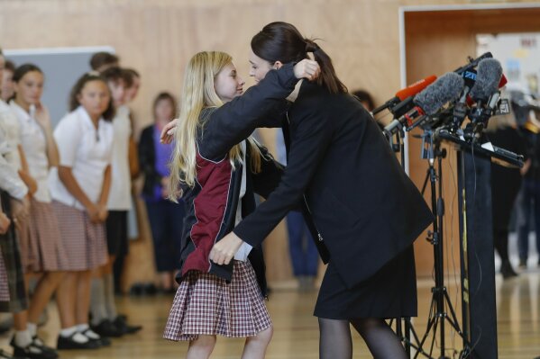 
              New Zealand's Prime Minister Jacinda Ardern, right, hugs and consoles a student during a high school visit in Christchurch, New Zealand, Wednesday, March 20, 2019. (AP Photo/Vincent Thian)
            