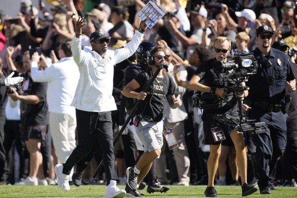 Colorado head coach Deion Sanders takes the field for the first half of an NCAA college football game against Nebraska, Saturday, Sept. 9, 2023, in Boulder, Colo. (AP Photo/David Zalubowski)