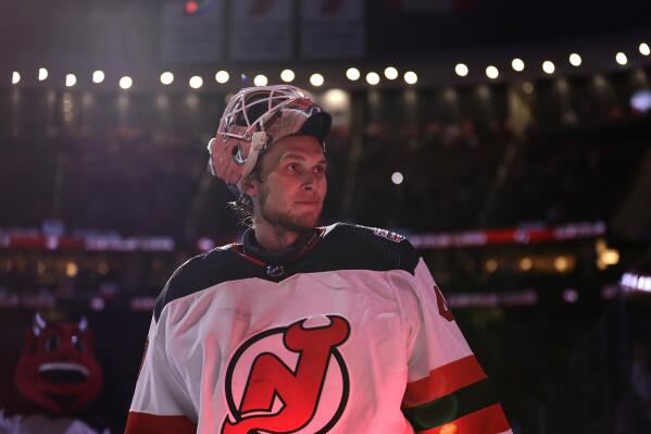 New Jersey Devils goaltender Akira Schmid skates off the ice after being named the second star of the game against the Philadelphia Flyers after an NHL hockey game Saturday, Feb. 25, 2023, in Newark, N.J. (AP Photo/Adam Hunger)
