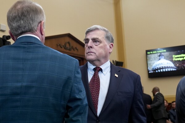 Retired Gen. Mark Milley, the former chairman of the Joint Chiefs of Staff, center, speaks with House Foreign Affairs Committee Chairman Mike McCaul, R-Texas, left, as the panel holds a hearing on the withdrawal from Afghanistan, at the Capitol in Washington, Tuesday, March 19, 2024. (AP Photo/J. Scott Applewhite)