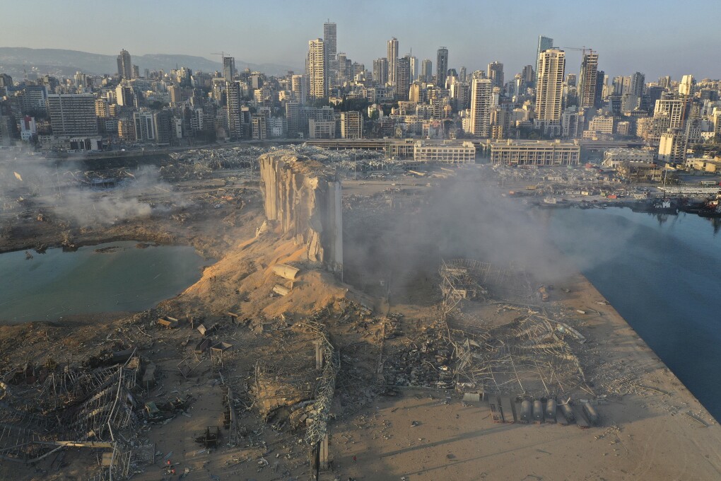 FILE - In this August 5, 2020 file photo, a drone picture shows the destruction after an explosion at the seaport of Beirut, Lebanon. The mental health impact of the Beirut explosion that killed more than 200 and wounded more than 6,000 continues to lay its heavy weight on those who managed to survive the day. The blast was caused by a fire of unknown origins that ignited nearly three thousand tons of ammonium nitrates that had been left to rot in a port warehouse for years. (AP Photo/Hussein Malla, File)