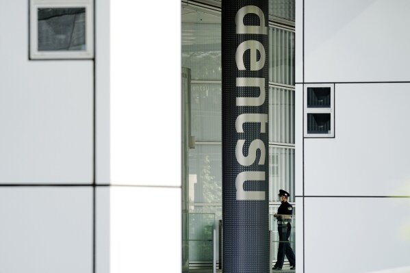 The headquarters of Japanese advertising company Dentsu Inc. is seen in Tokyo on June 5, 2020. Domestic sponsors have already contributed a record of $3.3 billion to help pay for the Tokyo Olympics. That's at least twice as much as any previous Games. Now they're being asked to pay millions more to cover some of the soaring costs of the one-year postponement. Dentsu helped land the Olympics, lined up the sponsors, and stands to profit with the Olympics opening on July 23, 2021. (AP Photo/Eugene Hoshiko)