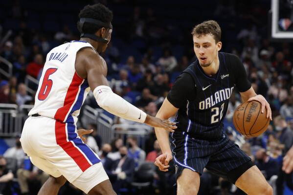 Orlando Magic forward Franz Wagner (22) drives to dribble past Detroit Pistons guard Hamidou Diallo (6) during the second half of an NBA basketball game Friday, Jan. 28, 2022, in Orlando, Fla. (AP Photo/Scott Audette)