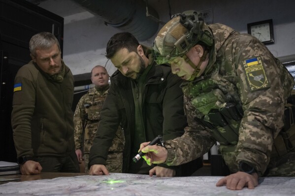 President of Ukraine Volodymyr Zelensky, Commander of the Ground Forces of Ukraine, Colonel-General.  Alexander Syrsky, right, and Roman Mashovets, deputy head of the presidential office, look at a map during their visit to the front-line city of Kupyansk in Ukraine's Kharkiv region on Thursday, Nov. 30, 2023.  (AP Photo/Efrem Lukatsky, File)