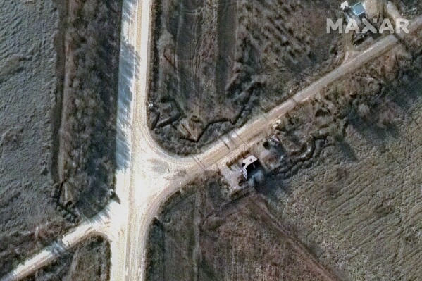 This satellite image provided by Maxar Technologies shows trenches dug near an intersection in Berdiansk, Ukraine on Dec. 19, 2022. Olena Yahupova, a 50-year-old civil administrator, described being forced by Russian soldiers to dig trenches for months at this site with other Ukrainian civilians. (Maxar Technologies via AP)