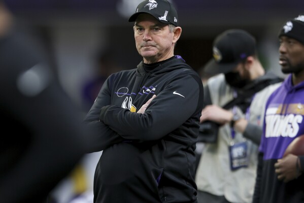 FILE - Minnesota Vikings head coach Mike Zimmer stands on the field prior to an NFL football game against the Chicago Bears, Jan. 9, 2022, in Minneapolis. The Dallas Cowboys have settled on a coaching reunion by deciding to bring back Zimmer as defensive coordinator to replace Dan Quinn. (AP Photo/Stacy Bengs, File)