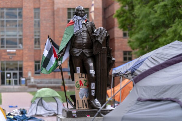 A statue of George Washington draped in a Palestinian flag and keffiyeh is seen at George Washington University as students demonstrate on campus during a pro-Palestinian demonstration against the Israel-Hamas war, Friday 26 April 2024, in Washington.  (AP Photo/José Luis Magana)