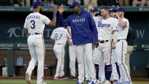 Texas Rangers' Leody Taveras (3), relief pitcher Alex Speas, center, Robbie Grossman, right center, and the rest of the team celebrate their 5-1 win over the Tampa Bay Rays following a baseball game, Wednesday, July 19, 2023, in Arlington, Texas. Speas made his major league debut in the game. (AP Photo/Tony Gutierrez)