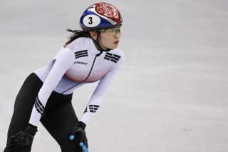 FILE - In this Feb. 10, 2018, file photo, Shim Suk-hee of South Korea reacts after the ladies' 3000 meters short-track speedskating relay in the Gangneung Ice Arena at the 2018 Winter Olympics in Gangneung, South Korea. Two-time Olympic champion Shim has been cut from South Korea's short track speedskating team after a reported text message exchange that suggested she may have intentionally tripped a teammate during the 2018 Winter Games. (AP Photo/Bernat Armangue, File)