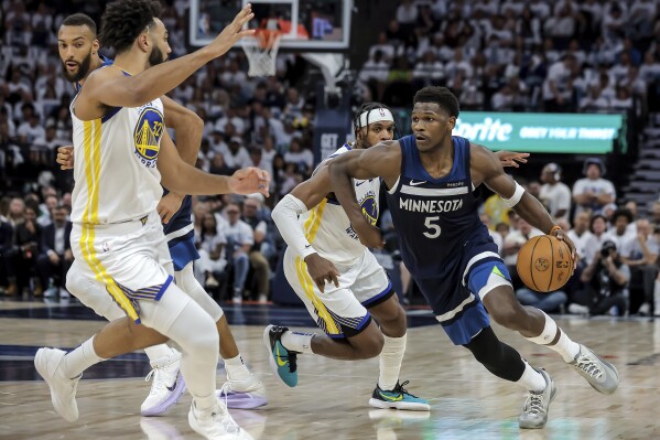 Minnesota Timberwolves guard Anthony Edwards (5) drives to the basket around Golden State Warriors defenders during the first half of Game 2 of an NBA basketball second-round playoff series Thursday, May 8, 2025, in Minneapolis. (Carlos Avila Gonzalez/San Francisco Chronicle via AP)