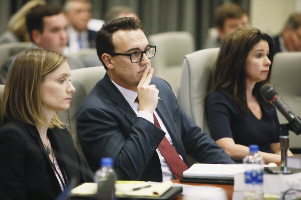 
              From left, Katelyn Love, Josh Lawson and Executive Director of the Board of Elections Kim Strach listen during a public evidentiary hearing on the 9th Congressional District investigation at the North Carolina State Bar in Raleigh, N.C., Monday, Feb. 18, 2019. (Juli Leonard/The News & Observer via AP, Pool)
            