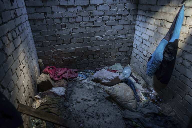 Debris lies on the floor of a building used by Russian forces where civilians said they were held and tortured, in Izium, Ukraine, Wednesday, Sept. 21, 2022. Torture was a constant, whether or not there was information to extract, according to every former detainee interviewed by the Associated Press. A U.N. report from June said 91% of prisoners “described torture and ill-treatment.” (AP Photo/Evgeniy Maloletka)