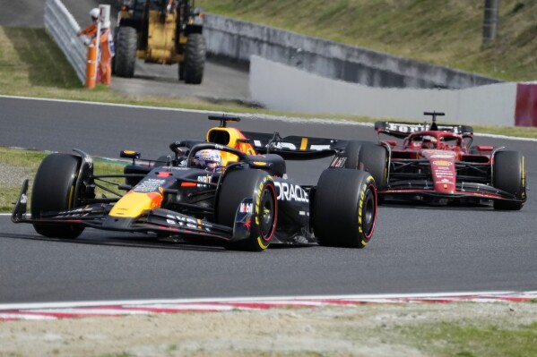 Red Bull driver Max Verstappen of the Netherlands, left, leads Ferrari driver Charles Leclerc of Monaco, right, during the Japanese Formula One Grand Prix at the Suzuka Circuit in Suzuka, central Japan, Sunday, April 7, 2024. (AP Photo/Hiro Komae)