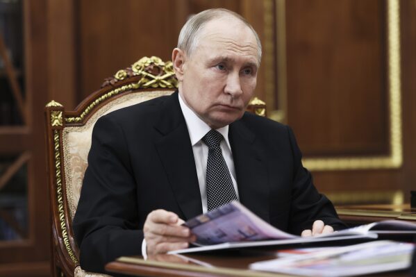 Russian President Vladimir Putin speaks with the governor of Perm territory Dmitry Makhonin during their meeting at the Kremlin in Moscow, Russia, Monday, March 10, 2025. (Mikhail Metzel, Sputnik, Kremlin Pool Photo via AP)