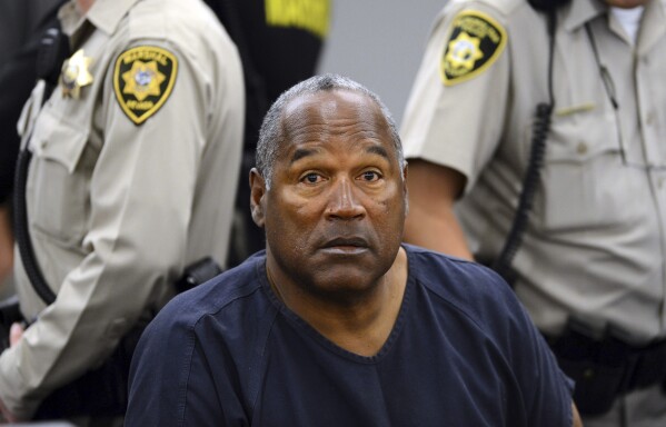 FILE - In this May 14, 2013, file photo, O.J. Simpson sits during a break on the second day of an evidentiary hearing in Clark County District Court in Las Vegas. Simpson, the decorated football superstar and Hollywood actor who was acquitted of charges he killed his former wife and her friend but later found liable in a separate civil trial, has died. He was 76. (AP Photo/Ethan Miller, Pool, File)