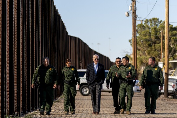 FILE - President Joe Biden talks with U.S. Border Patrol agents as they walk along a stretch of the U.S.-Mexico border in El Paso Texas, Sunday, Jan. 8, 2023. A deal to provide further U.S. assistance to Ukraine by year-end appears to be increasingly out of reach for President Joe Biden. Republicans are insisting on pairing the funding with changes to America’s immigration and border policies. (AP Photo/Andrew Harnik, File)