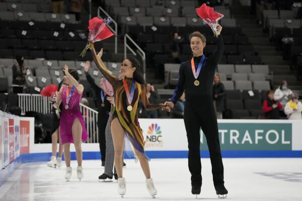 Madison Chock, center left, and Evan Bates wave after finishing first during the free dance at the U.S. figure skating championships in San Jose, Calif., Saturday, Jan. 28, 2023. (AP Photo/Tony Avelar)