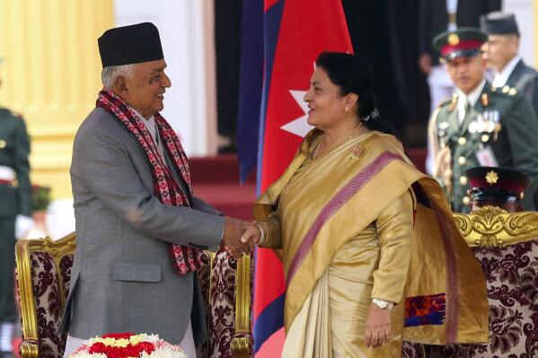 Outgoing President Bidhya Devi Bhandari, right, congratulates Nepal's newly elected president Ram Chandra Poudel, after he took the oath of office at the presidential building "Shital Niwas" in Kathmandu, Nepal, Monday, March 13, 2023. (AP Photo/Dipen Shrestha)