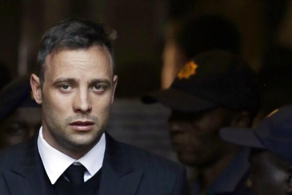 FILE - In this Wednesday, June 15, 2016, file photo, Oscar Pistorius leaves the High Court in Pretoria, South Africa, after his sentencing proceedings. South African former track star Oscar Pistorius has met with the father of Reeva Steenkamp, the woman he shot to death in 2013, as part of his parole process, the Steenkamp's family lawyer told The Associated Press on Friday July 1, 2022. (AP Photo/Themba Hadebe, File)