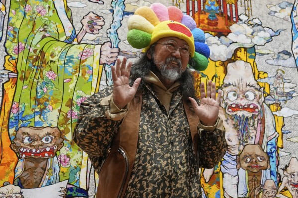 Takashi Murakami greets visitors to an exhibit of his art at the Cleveland Museum of Art in Cleveland, Thursday, May 15, 2025. (AP Photo/Sue Ogrocki)