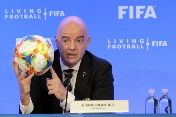 FILE - FIFA President Gianni Infantino holds a soccer ball as he speaks during a press conference after the FIFA Council Meeting, Friday, March 15, 2019, in Miami. FIFA is moving more than 100 jobs from its Swiss headquarters to Florida where a growing workforce is already working on organizing the 2026 World Cup. FIFA informed staff Tuesday, Sept. 26, 2023 the entire legal department plus audit, compliance and risk management teams will move from Zurich to Coral Gables near Miami. (AP Photo/Luis M. Alvarez, File)