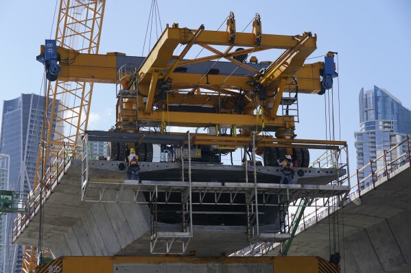 A construction crew works on a new segment of Interstate-395 on May 6, 2021, in Miami. (AP Photo/Marta Lavandier, File)